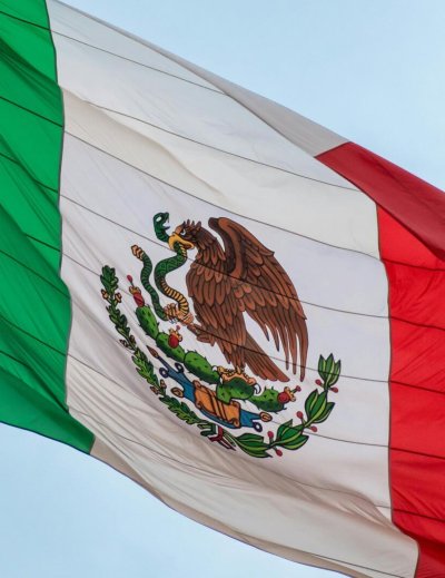 Mexican flag waving in the wind, symbolizing national pride and freedom.