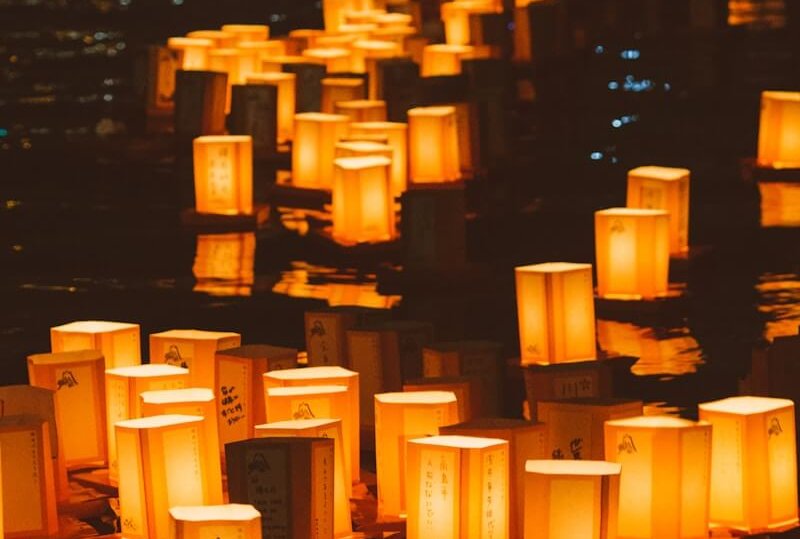 white and black Japanese candles on black surface