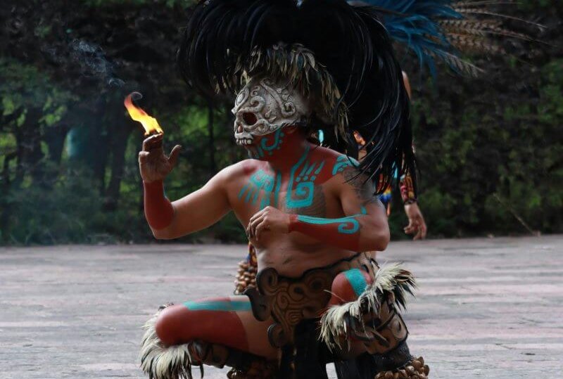 Aztec dancer performing a vibrant ritual dance in Chapultepec, Mexico City.