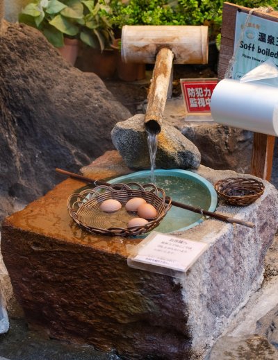 Onsen eggs simmering in baskets at a Japanese hot spring
