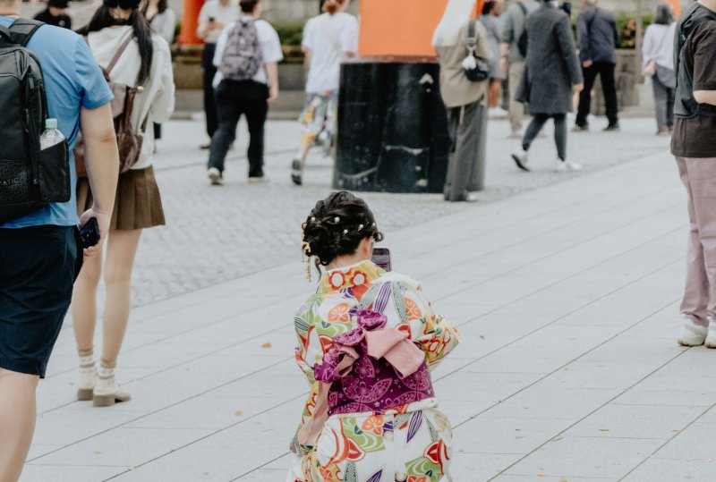 Little girl in kimono walking near Shinto shrine for Shichi-Go-San festival