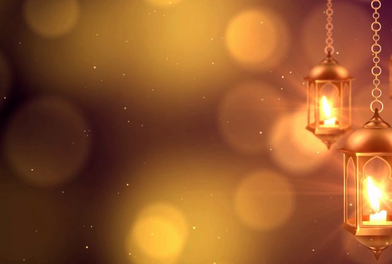 Traditional illuminated Ramadan lanterns with golden bokeh lights