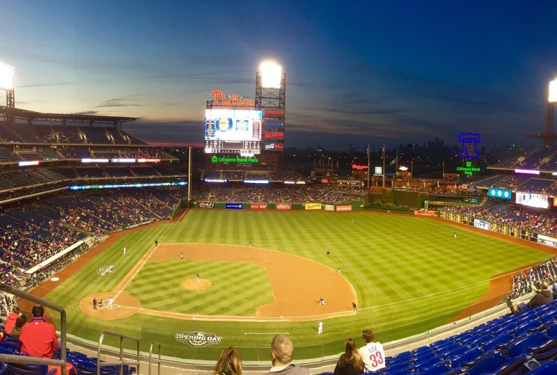Baseball stadium with spectators during evening game under stadium lights