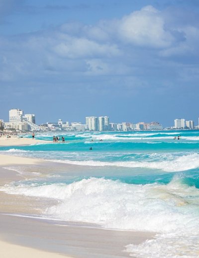 Pristine white sand beach meets crystal-clear turquoise waters along Cancún's famous hotel zone