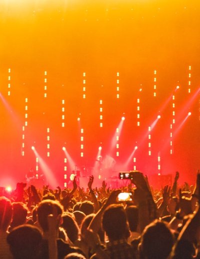 Thousands of music fans celebrate at an outdoor concert