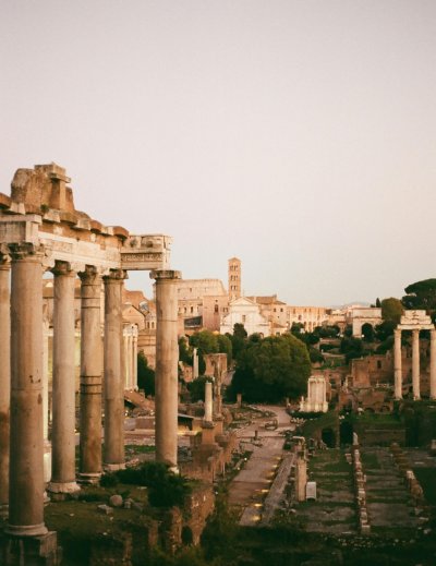 Ancient Roman Forum ruins with standing columns at sunset